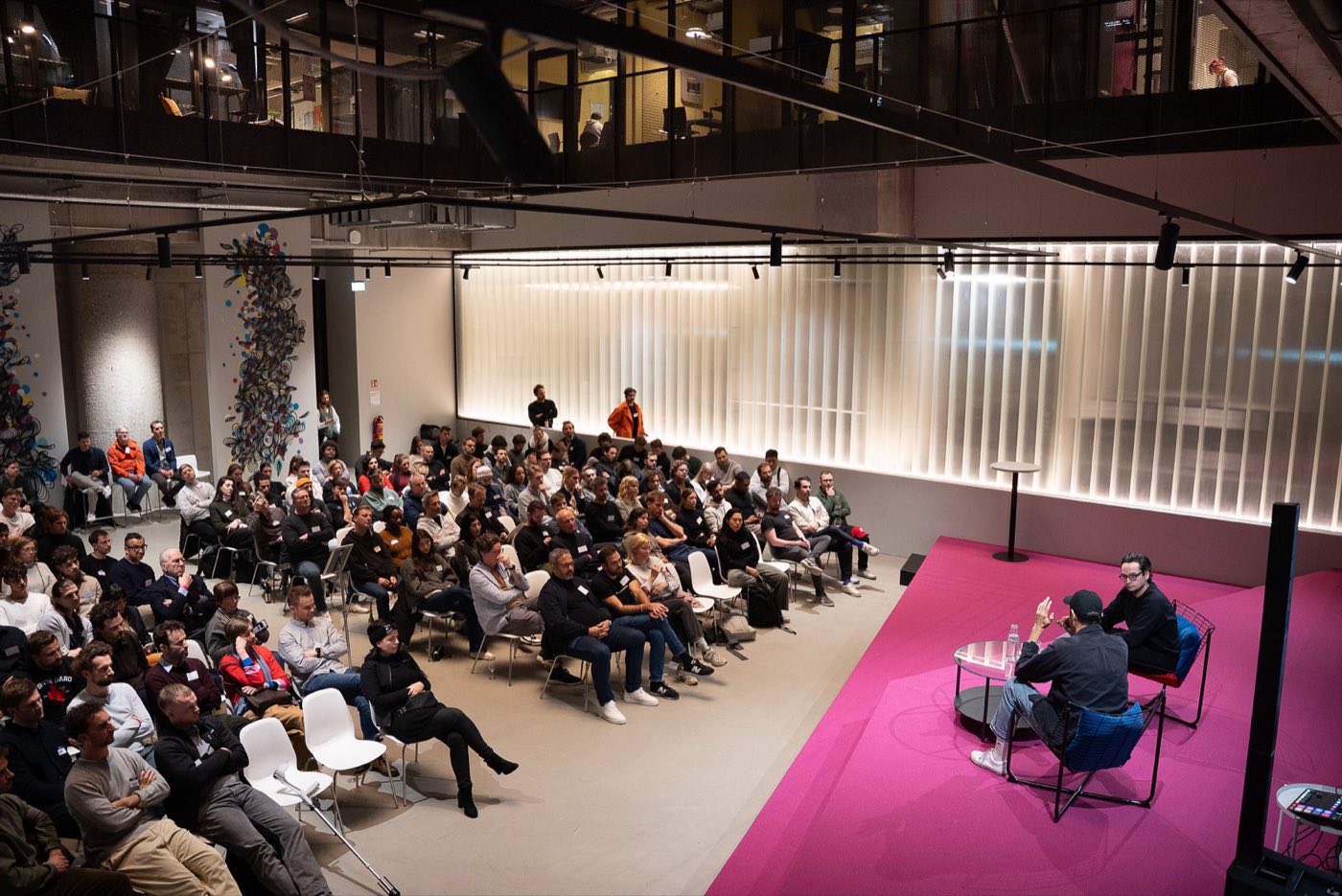 A panel on the Atrium's pink stage in front of a packed audience