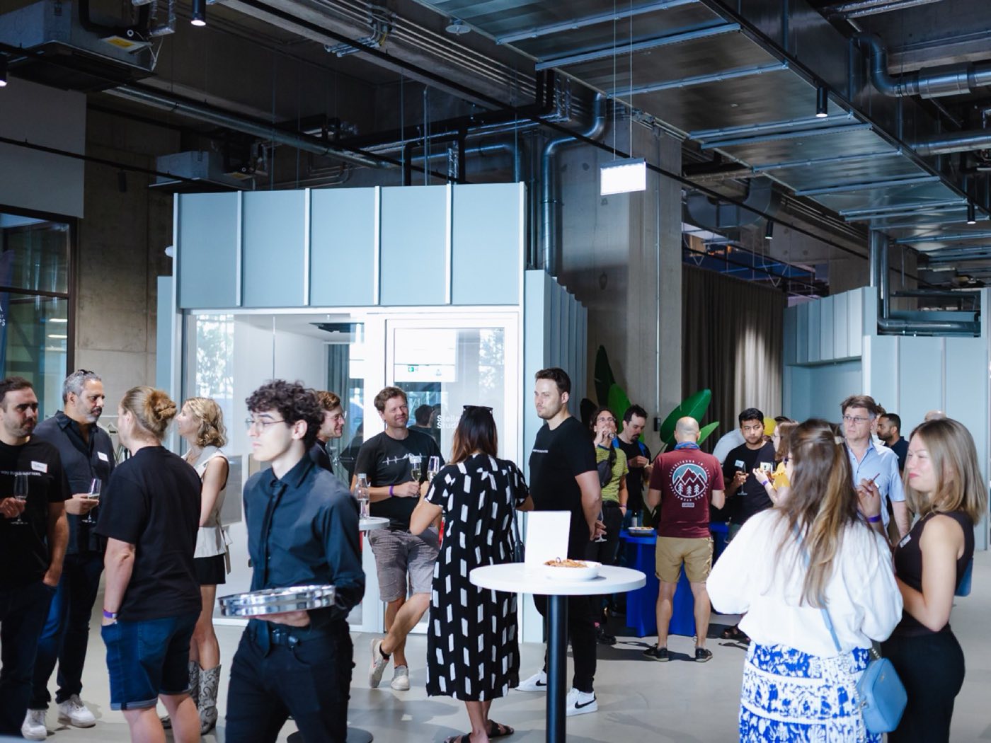 Guests mingling between the call pods on the coworking floor
