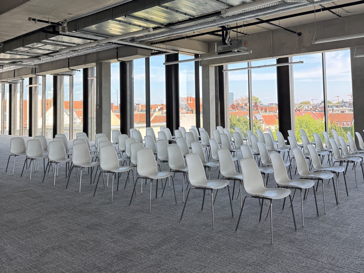 The Observatory, rows of seating before floor-to-ceiling windows looking out over Berlin rooftops